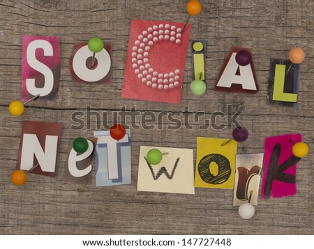 title made of letters from newspapers with pins on the wooden background