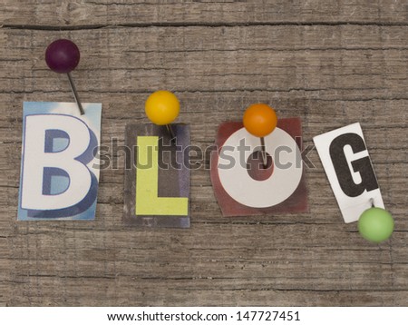title BLOG made of letters from newspapers with pins on the wooden background