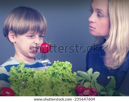 boy refusing to eat tomato