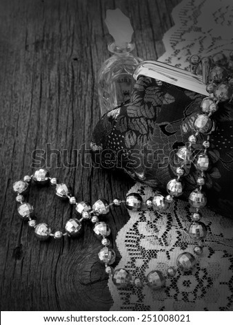 vintage handbag with shiny pearls on the wooden background