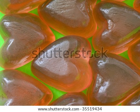 sweet and soft rubber hearts on green background