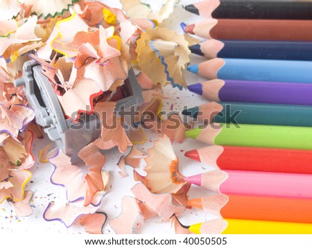 colored pencils with wooden shaving in recycle bin