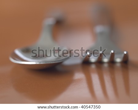 spoon and fork on brawn background
