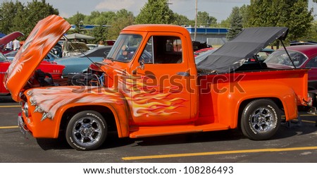 APPLETON, WI - JULY 21: 1955 Ford F-100 Pickup Truck painted orange with a cat design at the 18th Annual WVBO Classic Car Show at Fox Valley Technical College on July 21, 2012 in Appleton, Wisconsin.