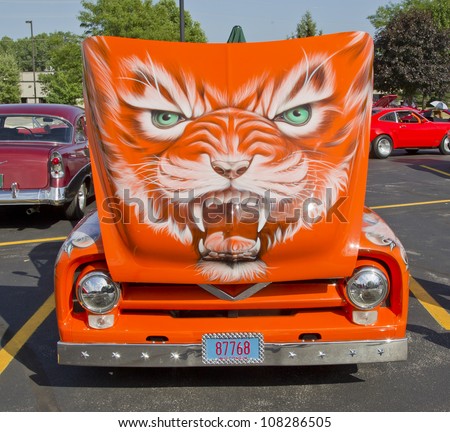 APPLETON, WI - JULY 21: 1955 Ford F-100 Pickup Truck painted orange with a cat design on hood at the 18th Annual WVBO Classic Car Show and Cruise on July 21, 2012 in Appleton, Wisconsin.