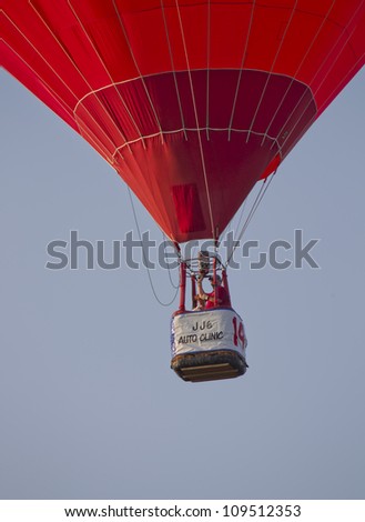 SEYMOUR, WI - AUGUST 3: A close up of the basket of a red hot air balloon just after lift off at the Balloon Rally at the Annual Hamburger Festival on August 3, 2012 in Seymour, Wisconsin.