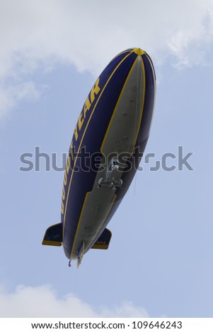 OSHKOSH, WI - JULY 27: The underside of the Good Year blimp Zeppelin, Spirit of Goodyear, flies high over the 2012 AirVenture at EAA on July 27, 2012 in Oshkosh, Wisconsin.