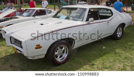 COMBINED LOCKS, WI - AUGUST 18: Side view of a white 1969 Pontiac GTO classic car at the 2nd Annual Horizon of Hope Generations Car and Truck Show on August 18, 2012 in Combined Locks, Wisconsin.