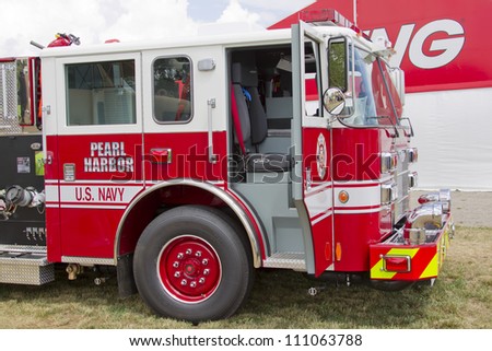 OSHKOSH, WI - JULY 27:  Side view of a Pierce red & white Fire Truck marked US Navy Pearl Harbor on display the 2012 AirVenture at EAA on July 27, 2012 in Oshkosh, Wisconsin.