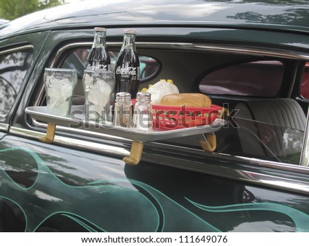 WAUPACA, WI - AUGUST 25: Drive thu tray on 1949 Mercury Coupe car with burger, coca cola, and fries at the 10th Annual Waupaca Rod & Classic Car Club Car Show on August 25, 2012 in Waupaca, Wisconsin.