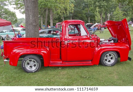 WAUPACA, WI - AUGUST 25: Red 1955 Ford F-100 Pickup Truck at the 10th Annual Waupaca Rod & Classic Car Club Car Show on August 25, 2012 in Waupaca, Wisconsin.