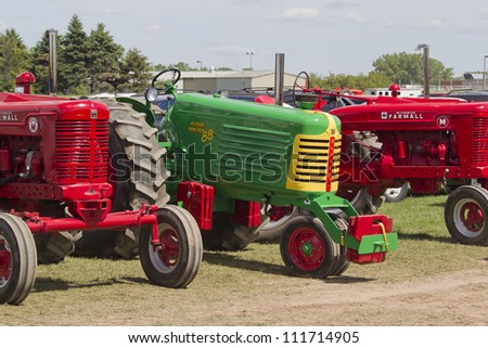 DE PERE, WI - AUGUST 18: Colorful vintage tractors lined up before competing at the Tractor Pull event at the Brown County Fair on August 18, 2012 in De Pere, Wisconsin.