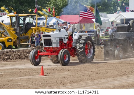 DE PERE, WI - AUGUST 18: A Case 1070 Orange & White Tractor pulling the track weights at the Tractor Pull event at the Brown County Fair on August 18, 2012 in De Pere, Wisconsin.