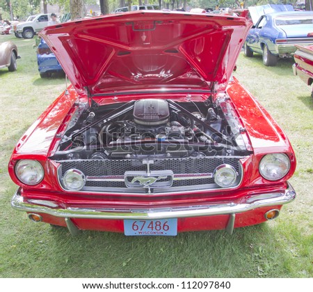 WAUPACA, WI - AUGUST 25: Front view of a 1960\'s red Ford Mustang car at the 10th Annual Waupaca Rod & Classic Car Club Car Show on August 25, 2012 in Waupaca, Wisconsin.