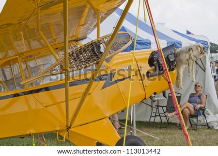 OSHKOSH, WI - JULY 27: Close up of Yellow Piper Cub Plane ready for Alaska on display with snowshoe and furs at the 2012 AirVenture at EAA on July 27, 2012 in Oshkosh, Wisconsin.