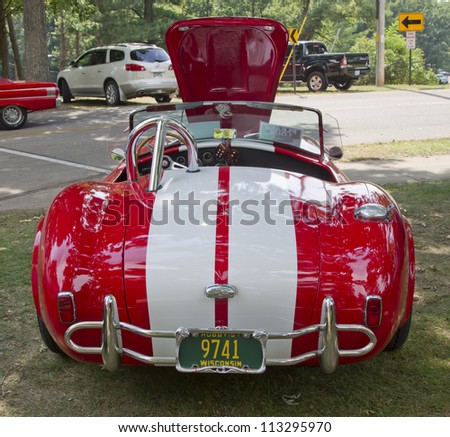WAUPACA, WI - AUGUST 25: Back of 1965 Red White Ford AC Cobra car at the 10th Annual Waupaca Rod & Classic Car Club Car Show on August 25, 2012 in Waupaca, Wisconsin.