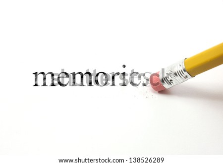 The word memories written with a pencil on white paper.  An eraser from a pencil is starting to erase the word memories.