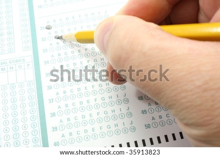 Taking a test filling out a bubble answer sheet with a number two pencil.