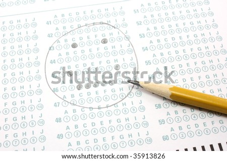 A smiley face is filled out on a bubble test sheet with a number two pencil.