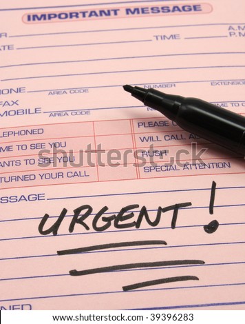 Urgent written with a black felt pen on a pink phone message pad.