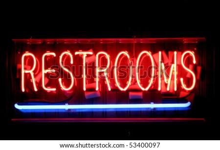 A red and blue restrooms neon sign.