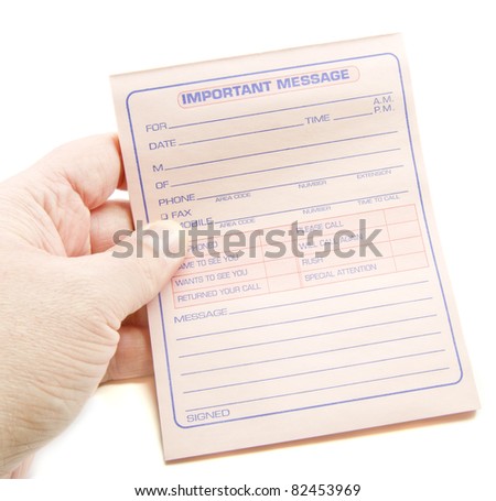 A hand holding out a pink important message phone paper pad.