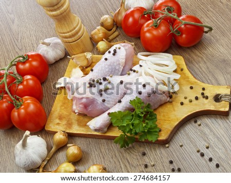 chicken drumstick with vegetables on wooden table