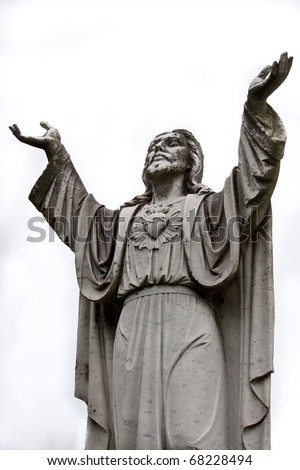 A jesus statue raising his hands to the heavens in prayer