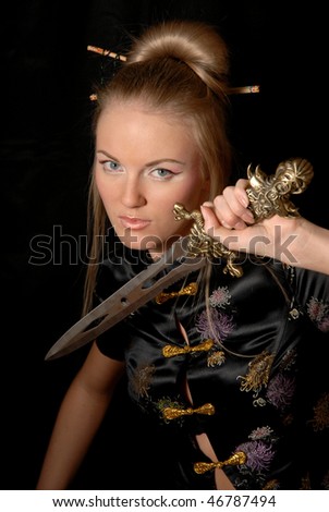 young girl in a Chinese costume with a dagger