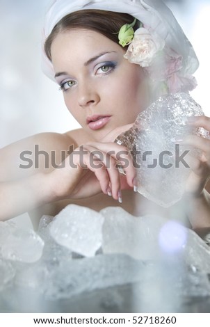 The beautiful young girl in a role of spring which heats winter ice