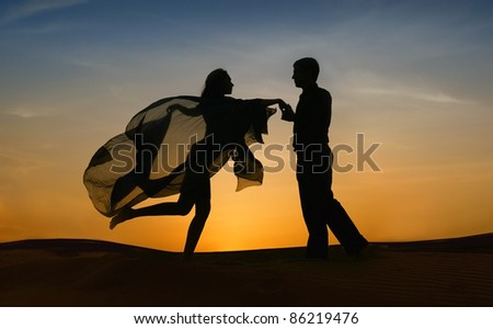 Beautiful elegant couple in love dancing at sunset.