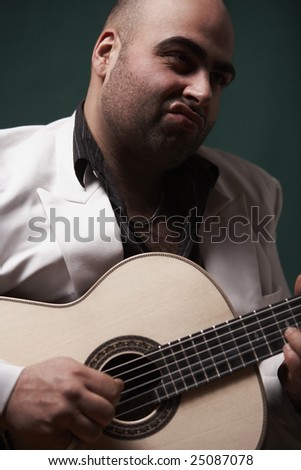 big man playing a guitar