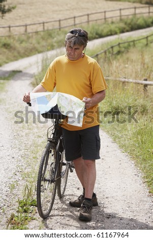 man with bike looking at map