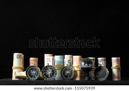 Orientation in  Business Compass and Money on a Black Background