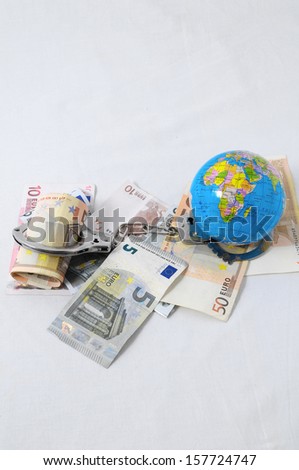 Financial Concept Handcuffs, Earth and Money on a White Background