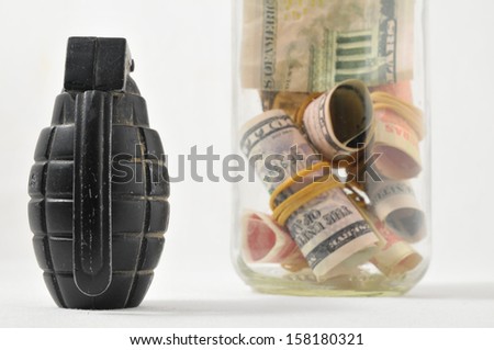 Money for War Concept Hand Grenade and Money