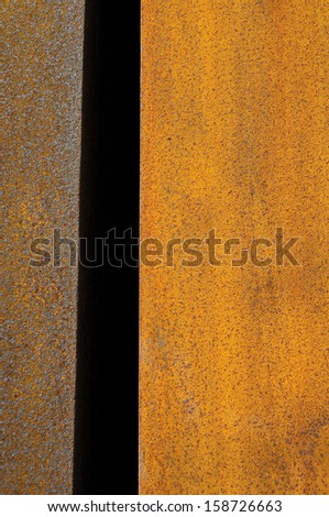 Orange Patterns on the Rusty Surface of the Metal