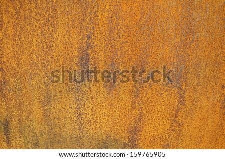 Orange Patterns on the Rusty Surface of the Metal