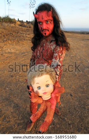 Latin American Man with Long Hairs Masked as a Devil in the Desert