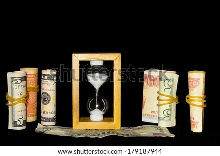 Buisness Time Concept Hourglass and Money on a Black Background