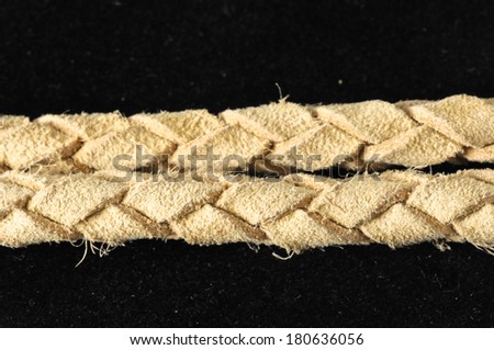 Brown Textured Braided Leather Necklace on a Black Background