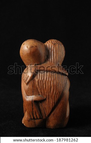 Lovers Sculpture made of Wood on a Black Background