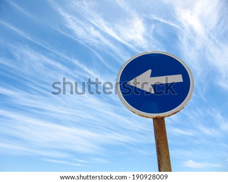 Wndy Clouds and One Way Sign On The Evening Atlantic Ocean Sky