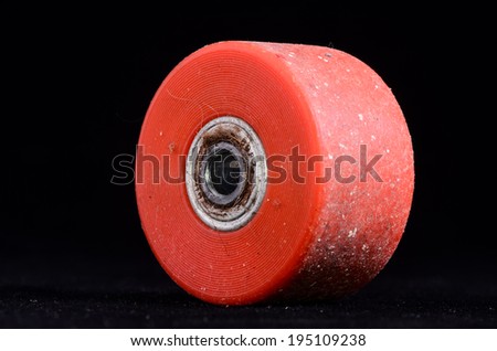 Old Vintage Consumed Skate Wheel on a Black Background