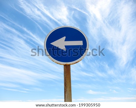Wndy Clouds and One Way Sign On The Evening Atlantic Ocean Sky