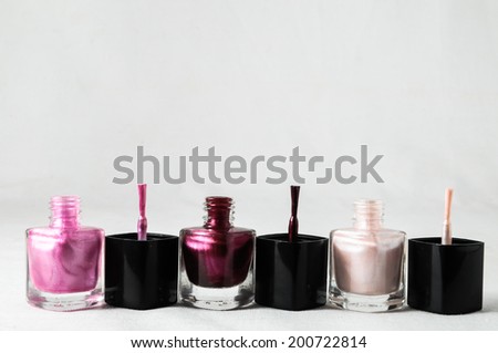 Colorful nail polish brush over white background