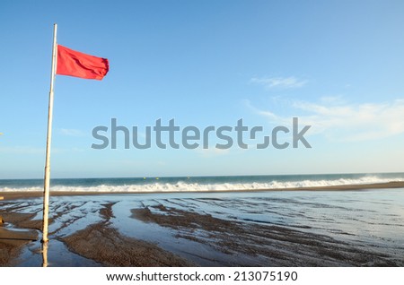 View of Storm Seascape and Red Flag on the Atlantic Ocean