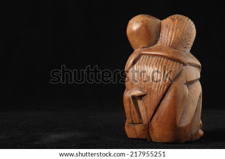 Lovers Sculpture made of Wood on a Black Background