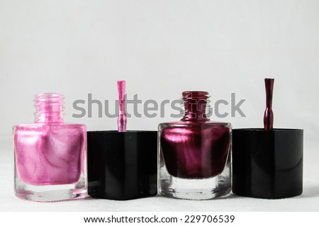 Colorful nail polish brush over white background