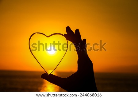 Love Concept Heart and Sun Setting on the Atlantic Ocean